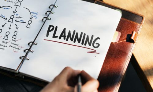 Woman writing and planning business strategy