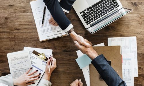 Businesspeople shaking hands together